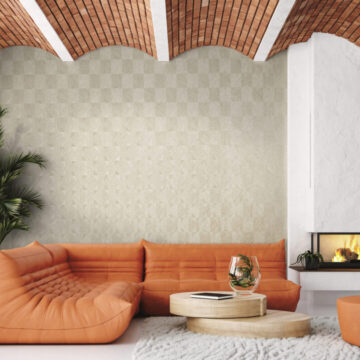 Modern living room loft with orange leather sofa and brick ceiling
