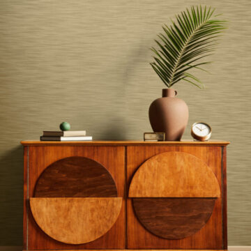 Interior design of neutral living room with stylish commode, tropical leaf in vase, mock up poster on the wall, carpet, decoration, clock and personal accessories in modern home decor. Template.